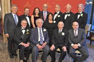 Group photo of 2022 Founder's Dinner Honorees in front of red NYMC step-and-repeat banner
