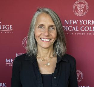 Headshot of Joy Solomon in front of Gray Background