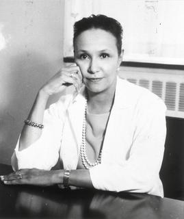 Black and white photograph of Jane Cooke Wright, M.D. She has short, dark hair, and is wearing a light colored sweater and pearl necklace.