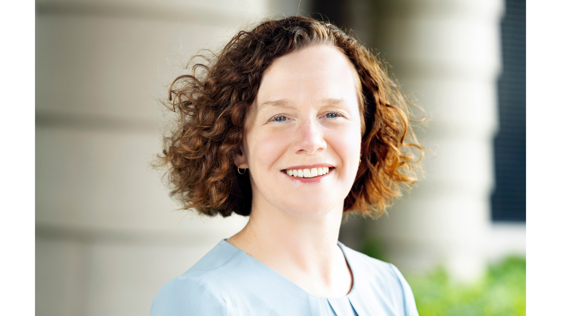 Woman smiling in blue shirt