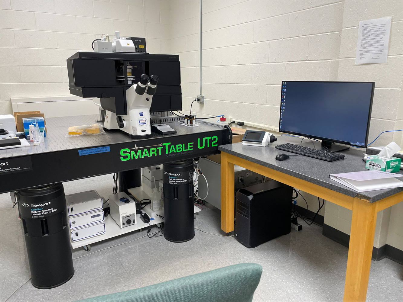 The 4D imaging system. A table with a microscope viewing area and a computer next to it