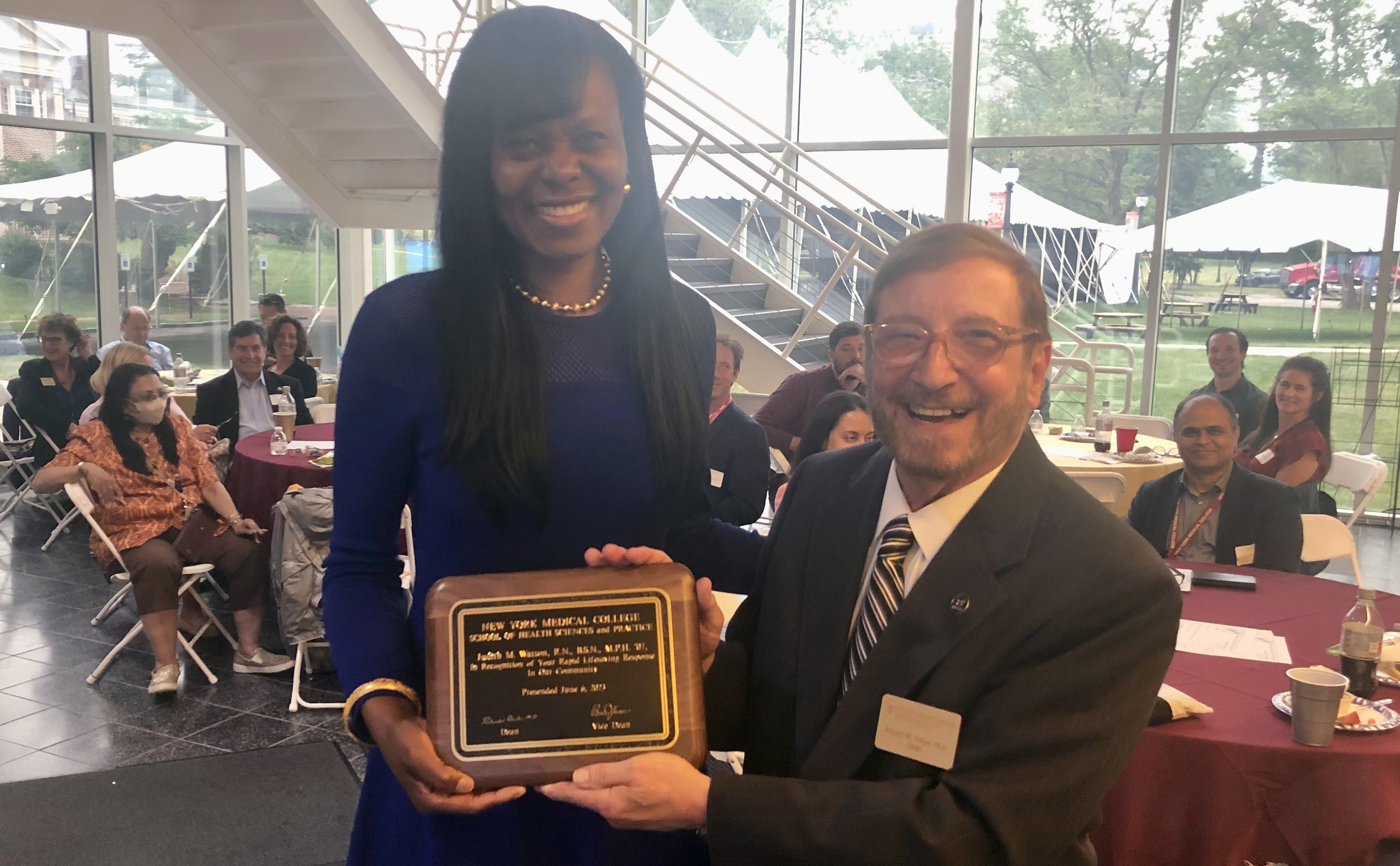 Judith Watson being presented her award by SHSP dean, Robert W. Amler, at the SHSP faculty meeting