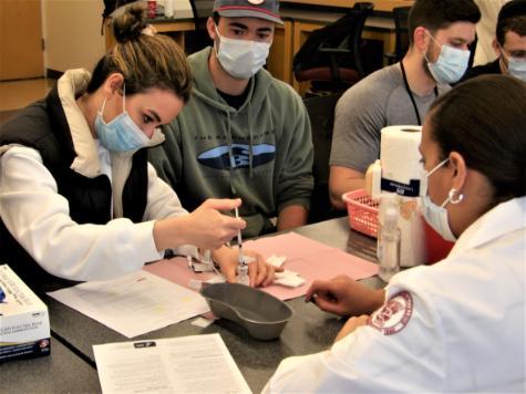 Student giving vaccination