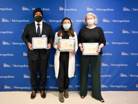 Award dinner at Met Residency Research Day in front of podium with their awards