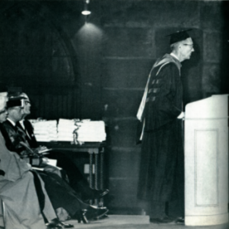 J. Frederick Eagle Jr., M.D. standing at podium in graduation regalia.