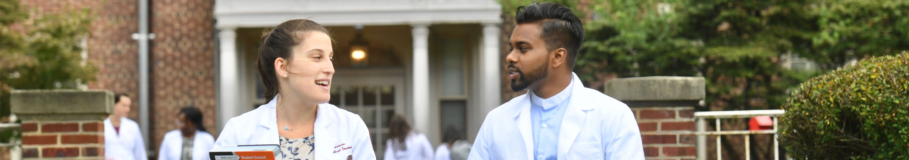 Two SOM students talking outside on campus