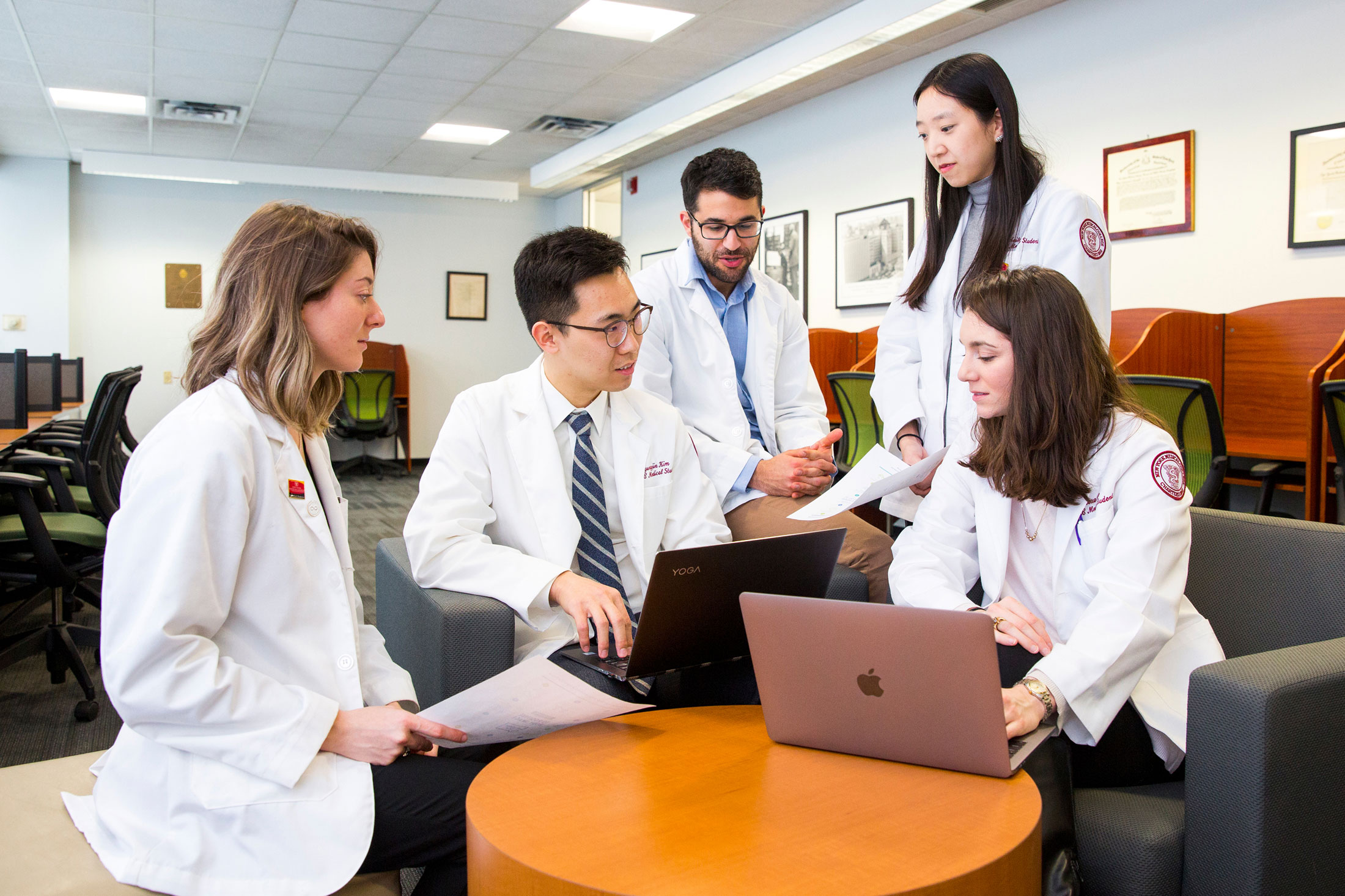 nymc medical students gathered around a laptop